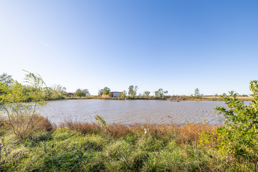 Coffey 61 - Oil Income, 8 Acre Pond, Big Shop & Home with Unlimited Potential