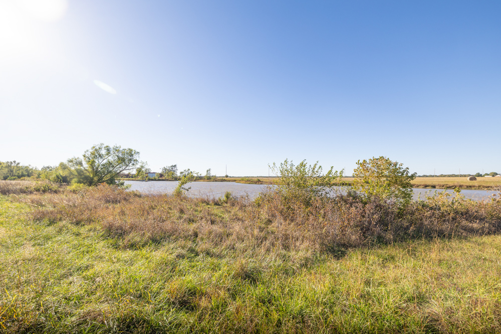 Coffey 61 - Oil Income, 8 Acre Pond, Big Shop & Home with Unlimited Potential
